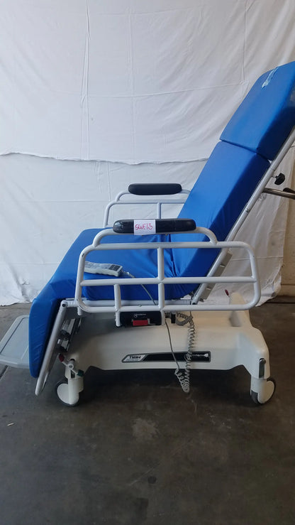 Blue padded TransMotion Medical TMM4 multi purpose stretcher chair with white metal frame and casters for patient transport