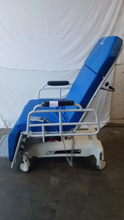 Blue padded multi purpose stretcher chair with white metal frame and casters by transmotion medical tmm4