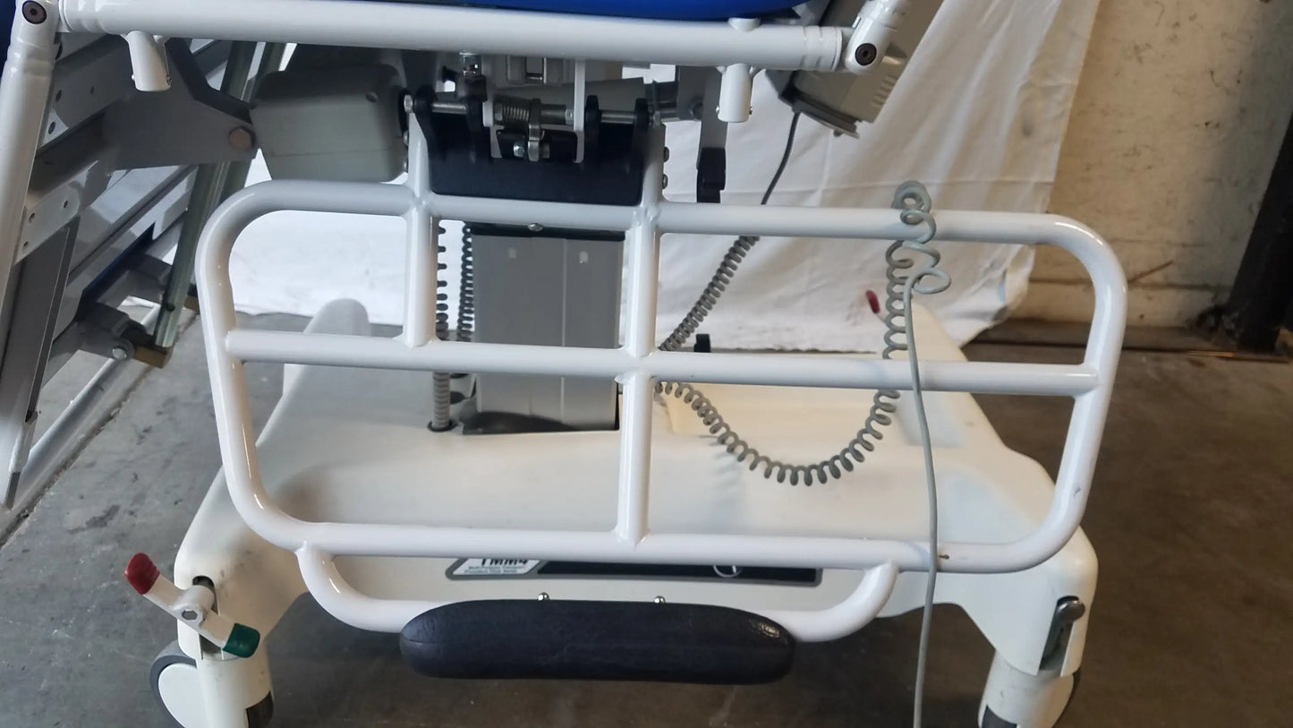 White metal safety rail with black rubberized footrest on TransMotion Medical TMM4 multi purpose stretcher chair