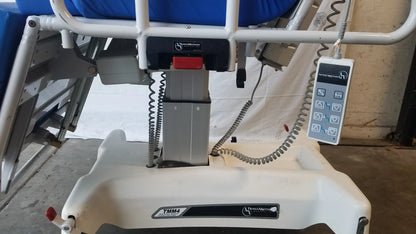 White plastic TransMotion Medical TMM4 multi purpose stretcher chair with blue cushion and control panel