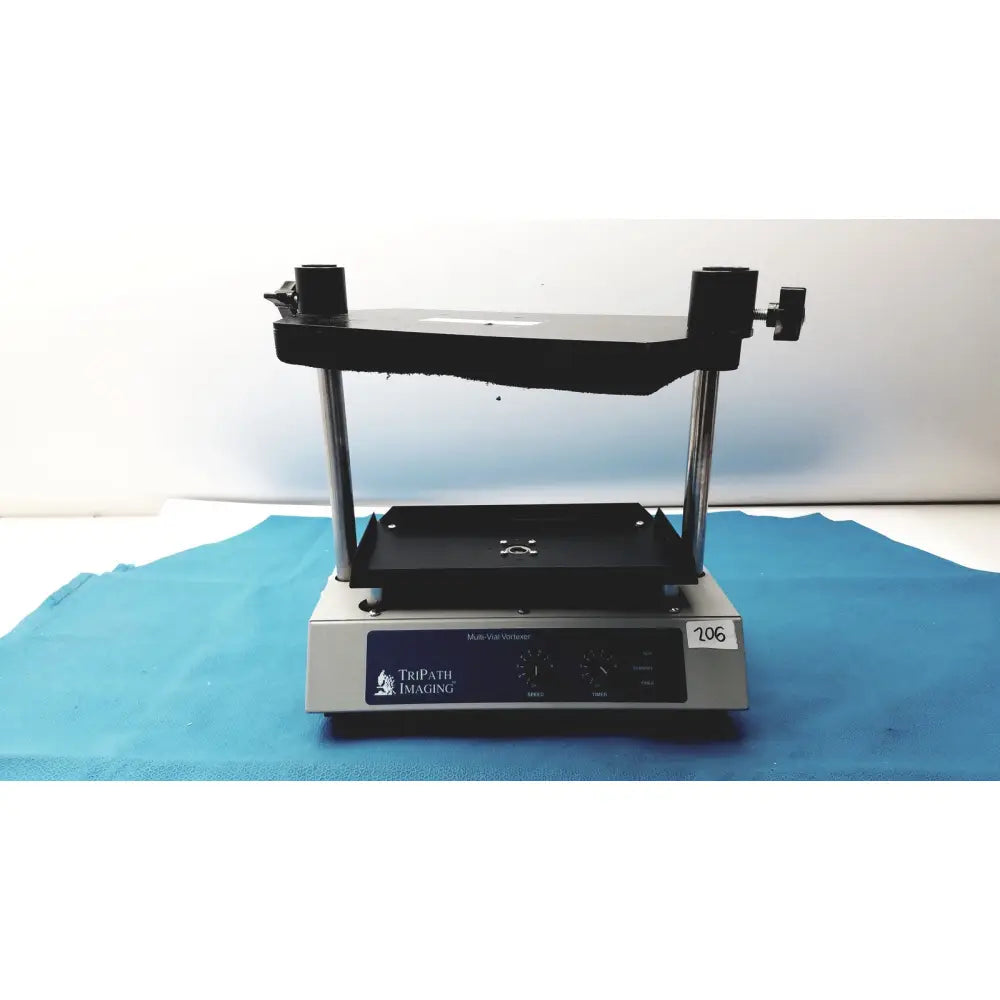 Silver and black tripath imaging multi-vial vortexer 30cr000106 with adjustable clamps and blue-vax warmer
