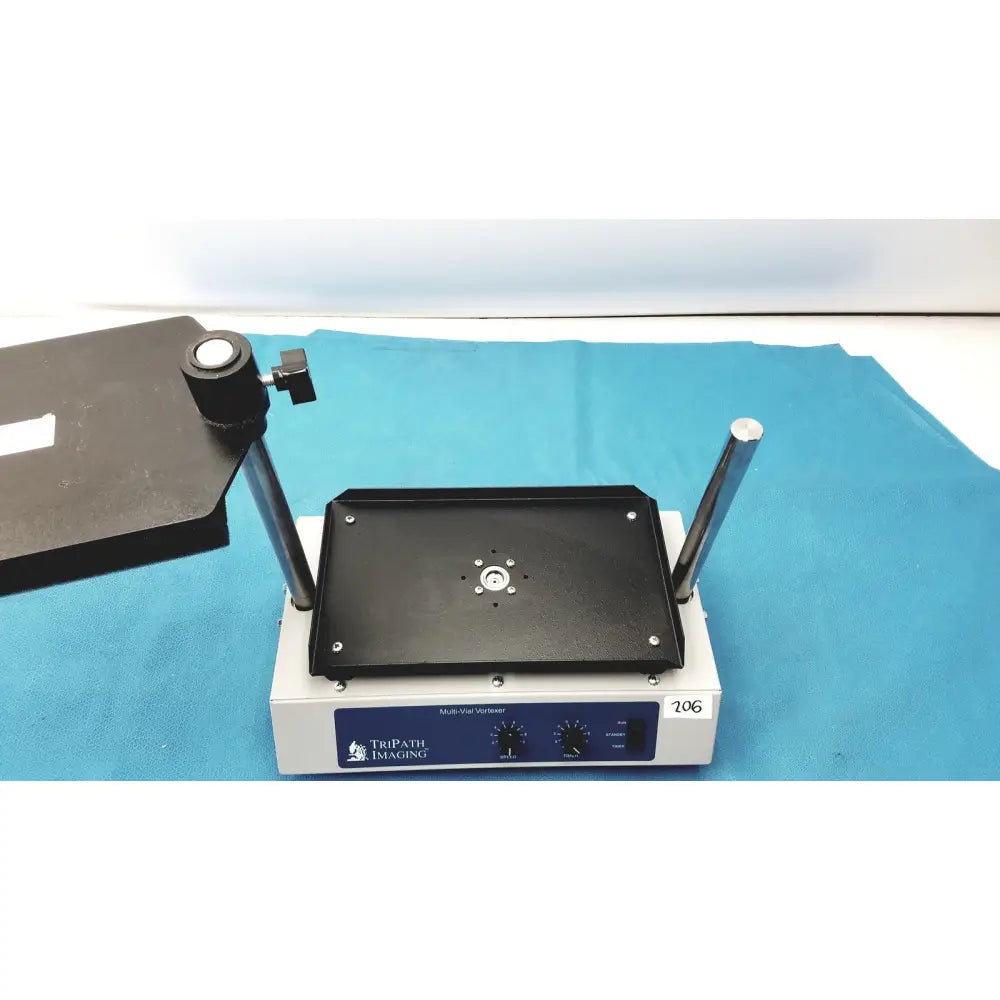 Black rectangular vortexer 30cr000106 with silver metal rods and central mount on white tripath imaging multi-vial base