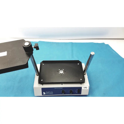 Black rectangular vortexer 30cr000106 with silver metal rods and central mount on white tripath imaging multi-vial base