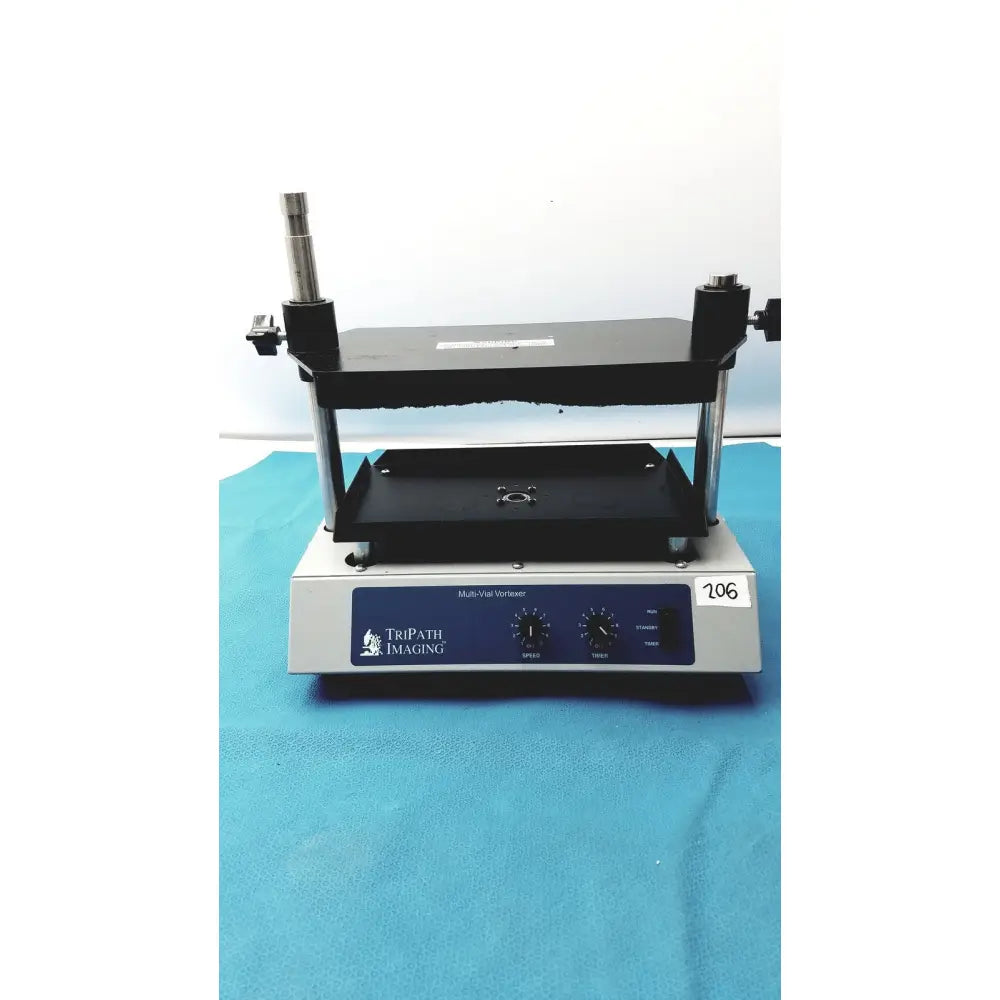 Tripath imaging multi-vial vortexer 30cr000106 with black platform silver base and three knobs on blue control panel