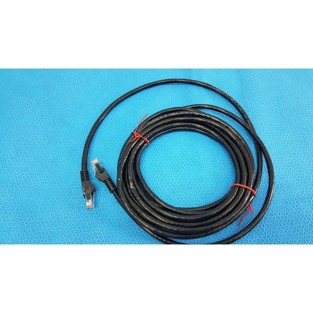 Black tripp lite 15ft cat6 patch cable with rj45 connectors coiled and secured by red ties for gigabit networking