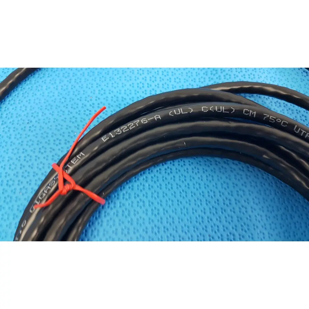 Black coiled tripp lite 15ft cat6 patch cable with white specifications and red tie for gigabit networking use