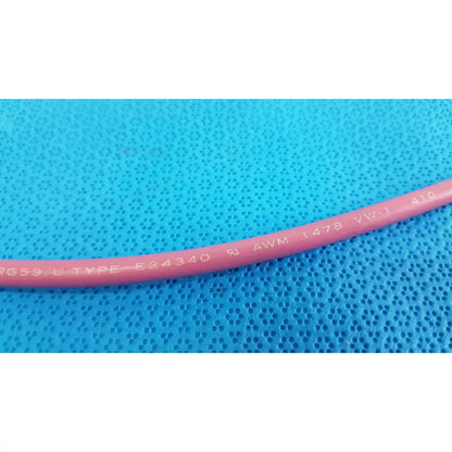 Pink insulated Trompeter 14949-PCW-24-75 ohm video patch cord showing printed specifications on the cable