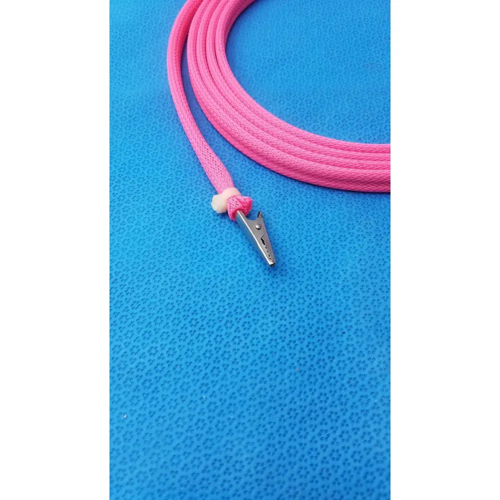 Pink braided cable with a silver metal clip and male plug for reuse medical applications