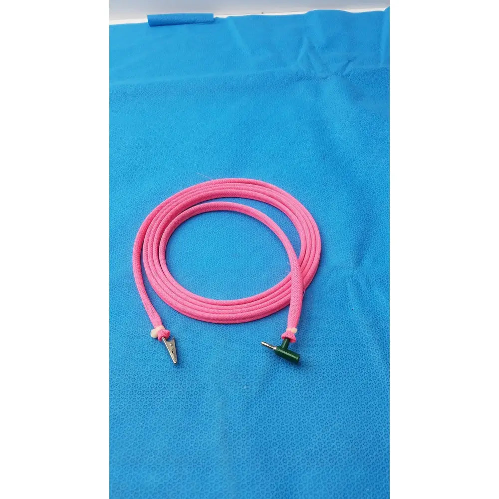 Two sides pink cable with a metal alligator clip and green male plug for reuse medical applications