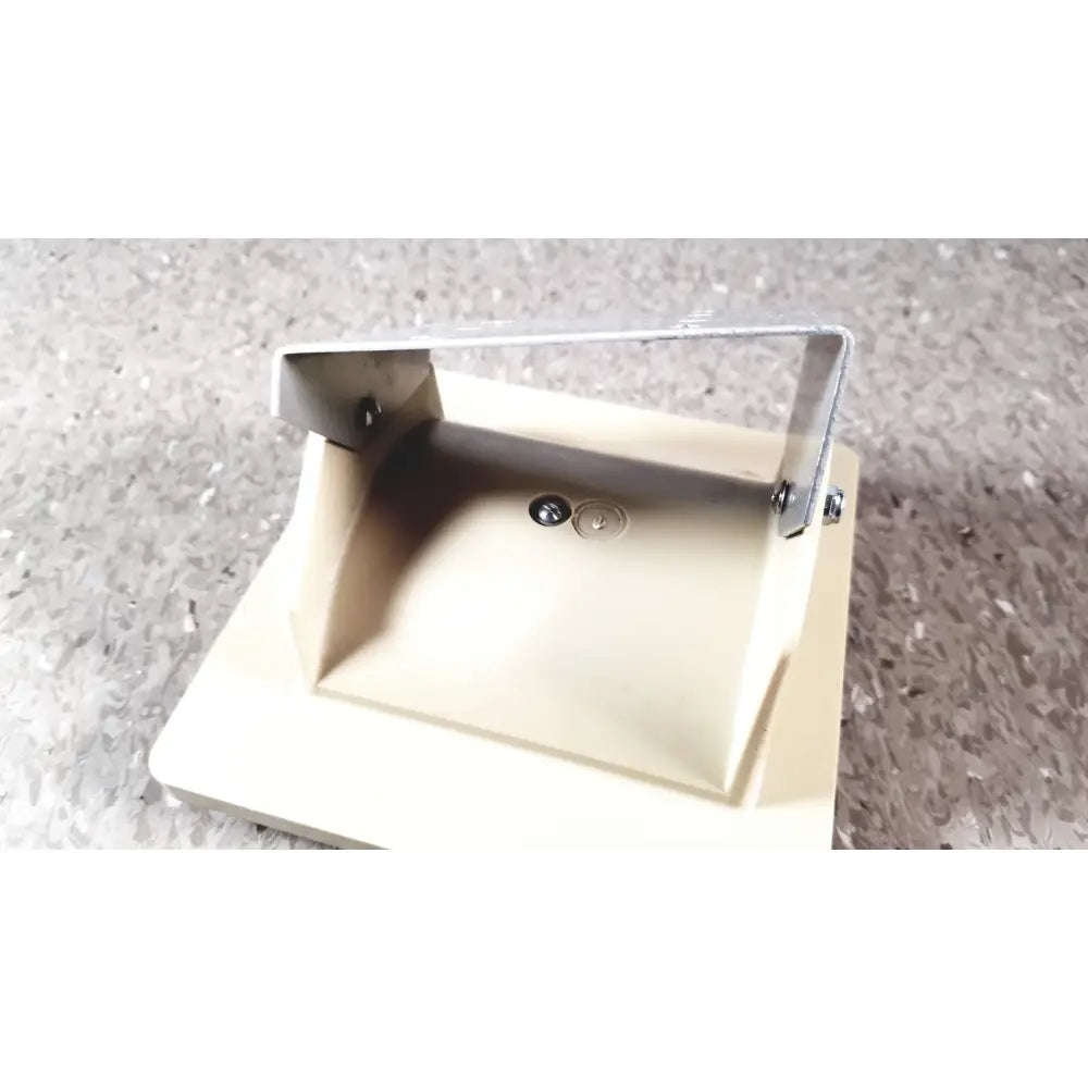 Beige plastic soap dish with silver metal bracket and two circular holes base for tycos lifetime certified sphygmomanomet