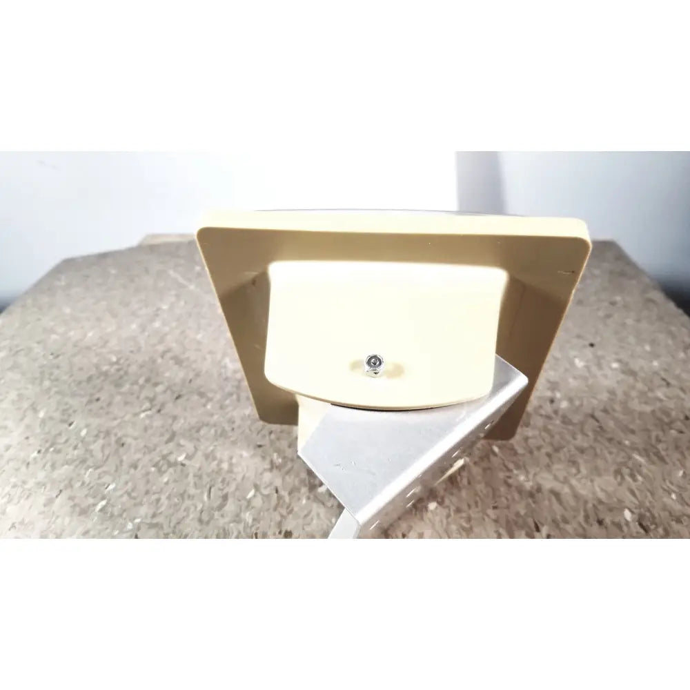 Beige plastic wall-mounted light fixture with silver screw for tycos lifetime certified sphygmomanomet