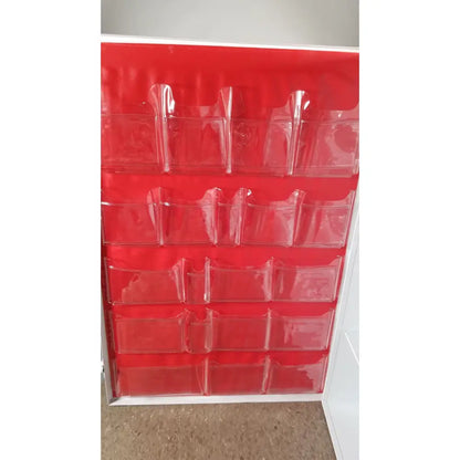 Red plastic organizer with clear pockets arranged in a grid for the uline h-5951 3-shelf aid cabinet