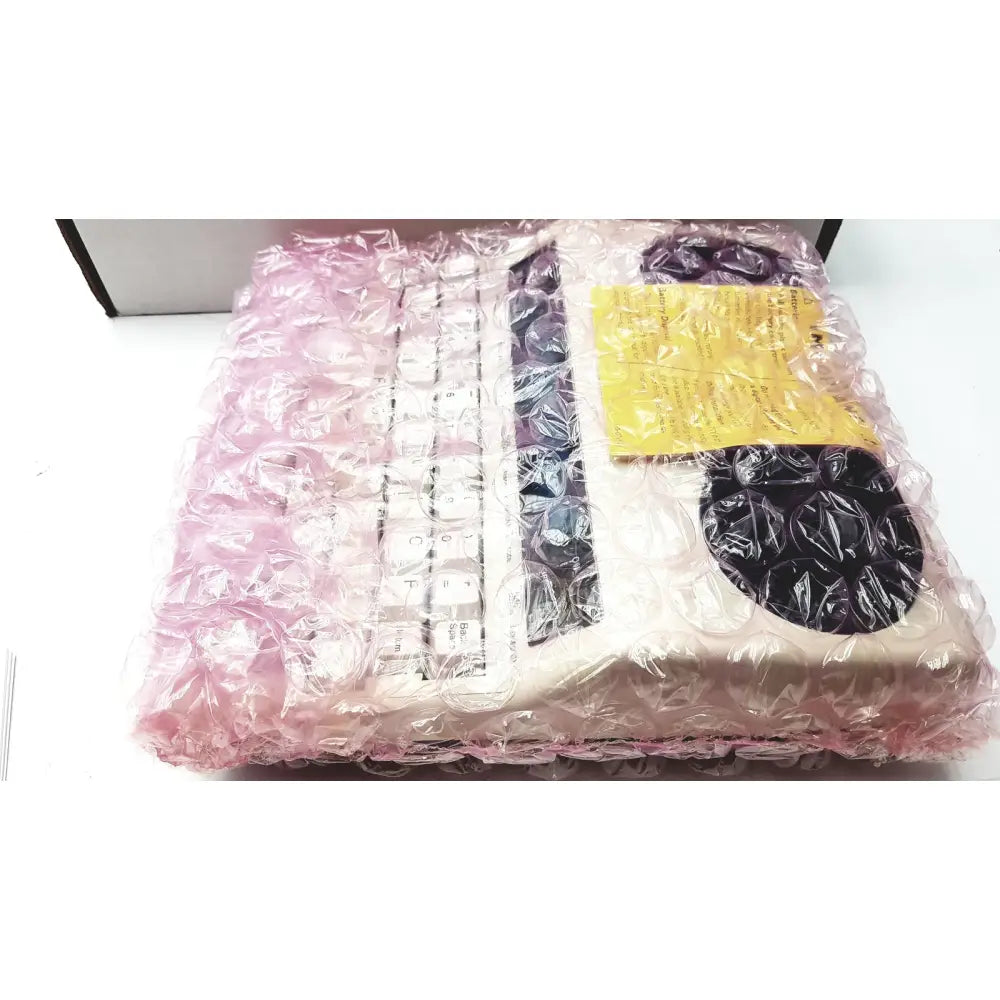 Beige ultratec superprint telephone printer tty with white keys and black accents wrapped in pink bubble wrap
