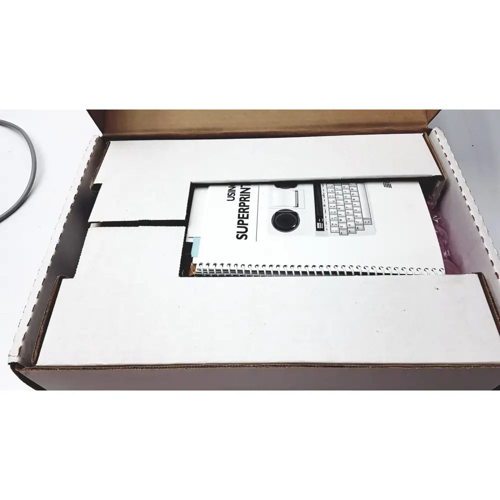 White spiral-bound manual titled using superprint with black-and-white early computer keyboard and printer illustration for ultratec superprint telephone printer tty