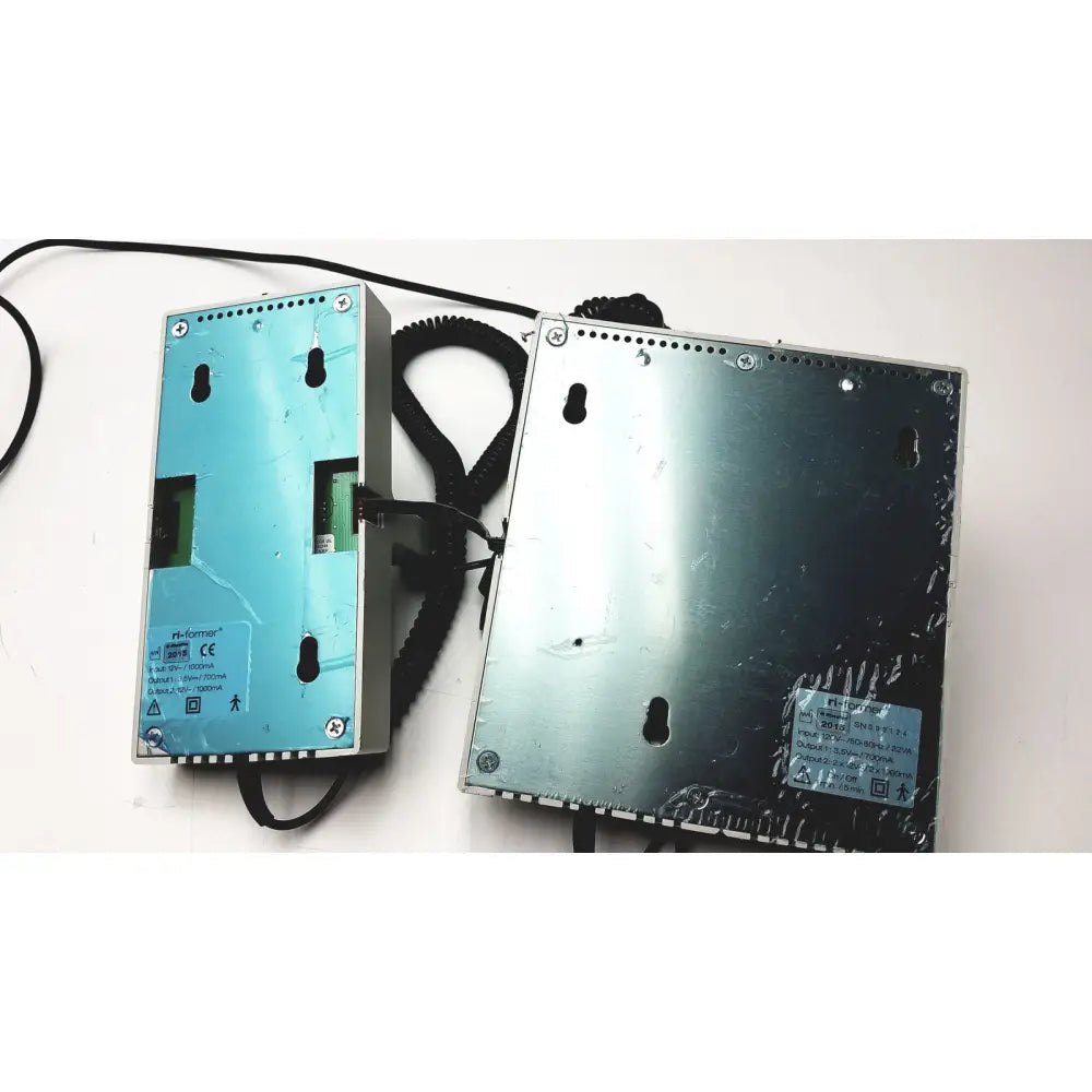 Two silver metal ulvac air compressor units with black cables and specification labels for industrial applications