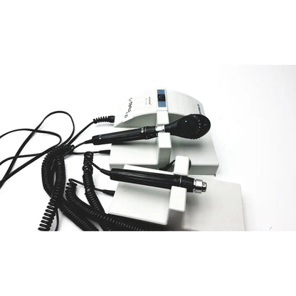 White ulvac air compressor unit model with black handheld probes and coiled cords for industrial application