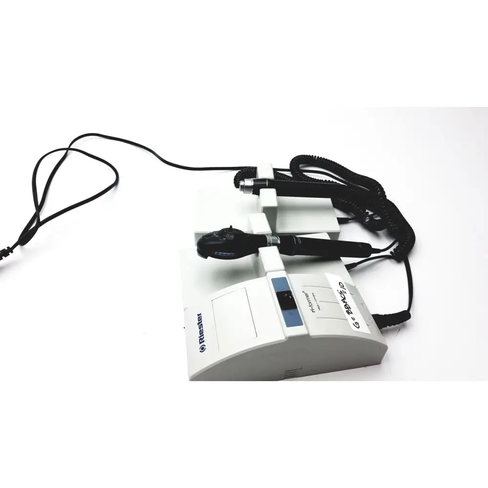 White rieker medical examination device with black handheld probes and coiled cords for ulvac air compressor unit model