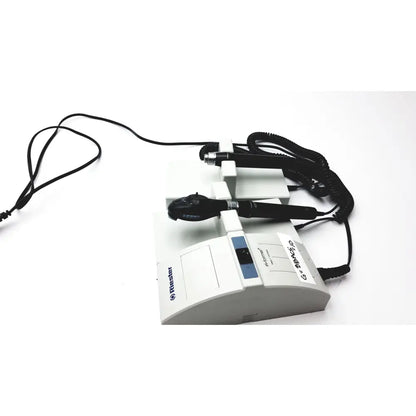 White rieker medical examination device with black handheld probes and coiled cords for ulvac air compressor unit model