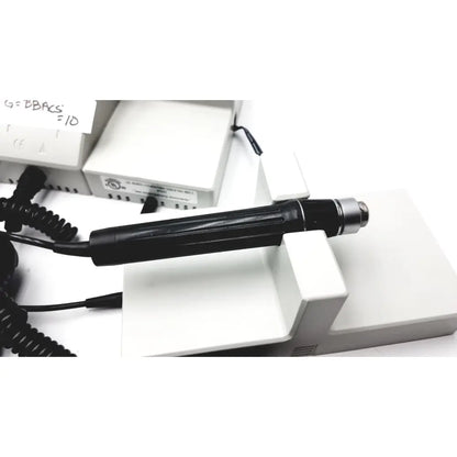 Black handheld dental drill with metallic silver tip and textured grip for ulvac air compressor unit model industrial use
