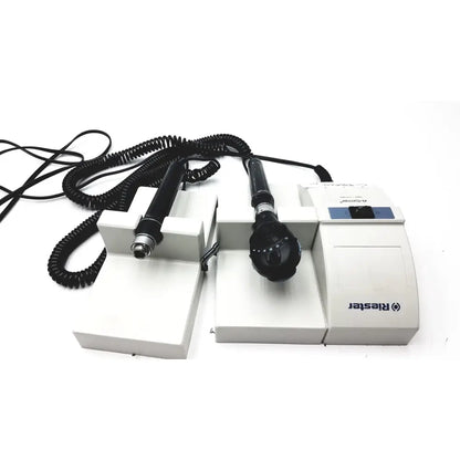 White rieker medical device with two black handheld probes and coiled cables for ulvac air compressor unit model