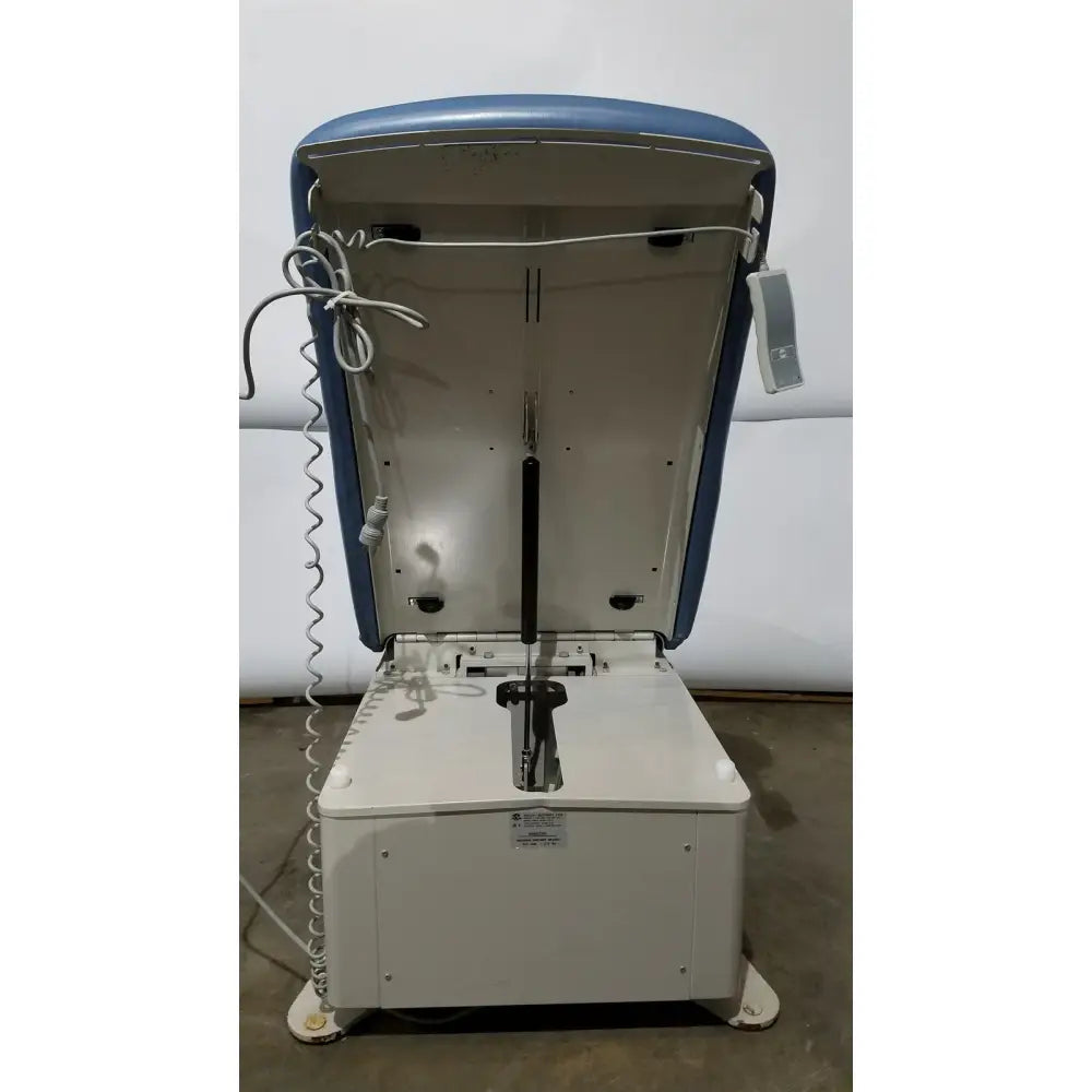 Umf 4070 power table with hand control featuring blue and white cushioned top metal frame and coiled cable medical equipment