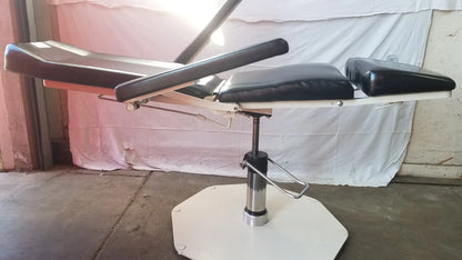 Black padded umf medical 8675 adjustable phlebotomy chair with adjustable sections and white octagonal base