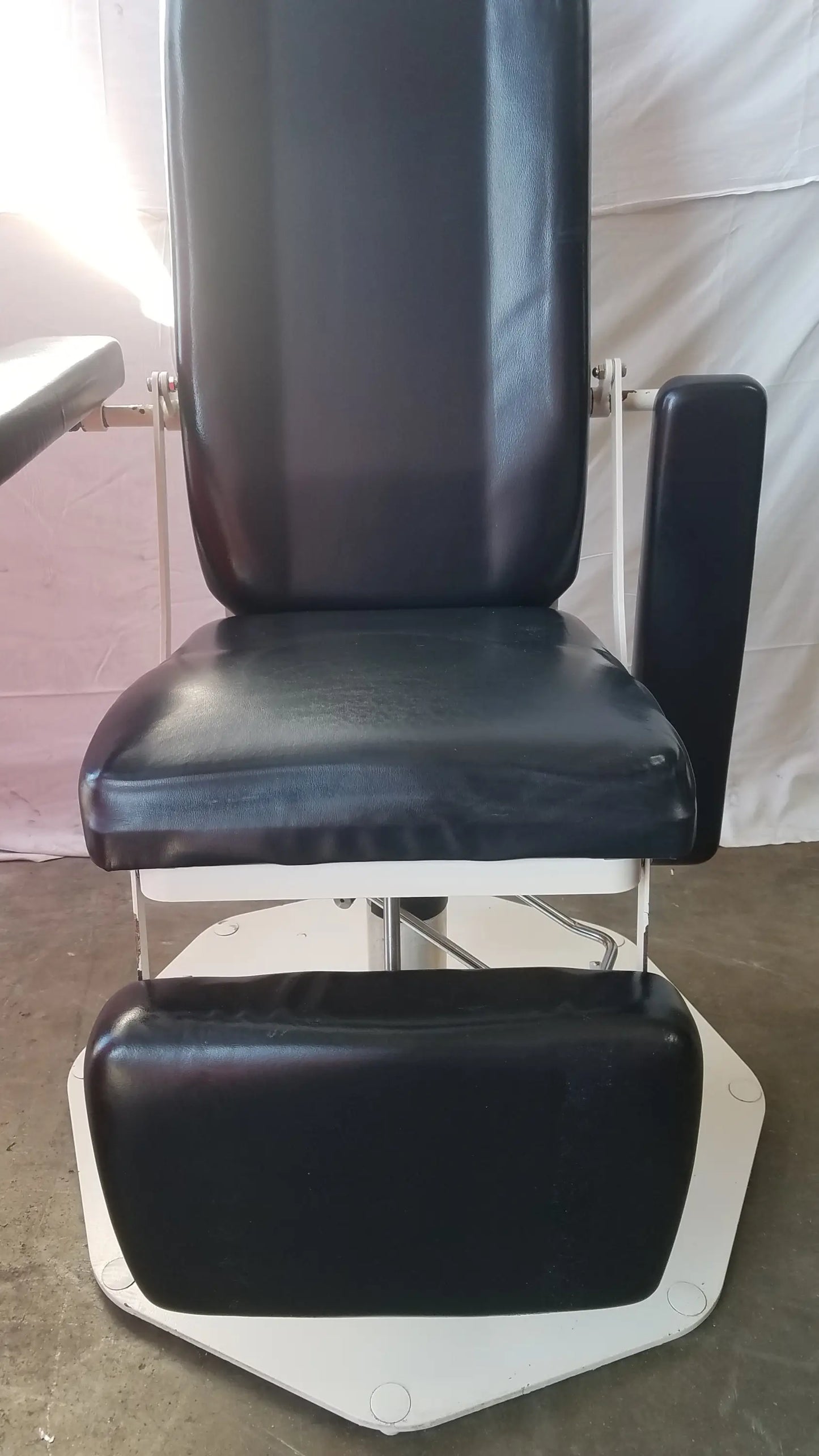 Black leatherette adjustable phlebotomy chair with white metal frame and footrest umf medical 8675 model