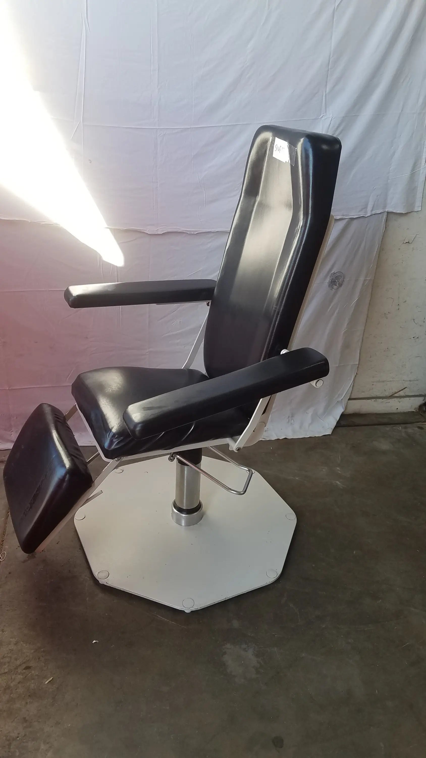 Black leatherette UMF Medical 8675 adjustable phlebotomy chair with white octagonal base and chrome accents