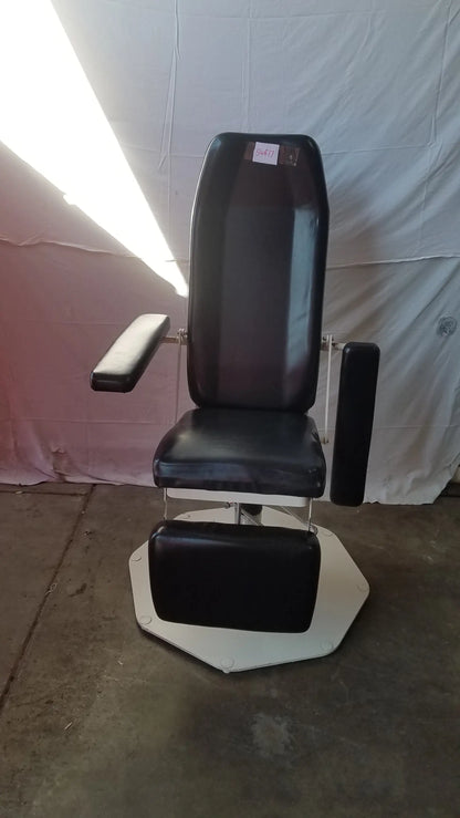 Black leather adjustable phlebotomy chair with chrome frame and white octagonal base for medical use