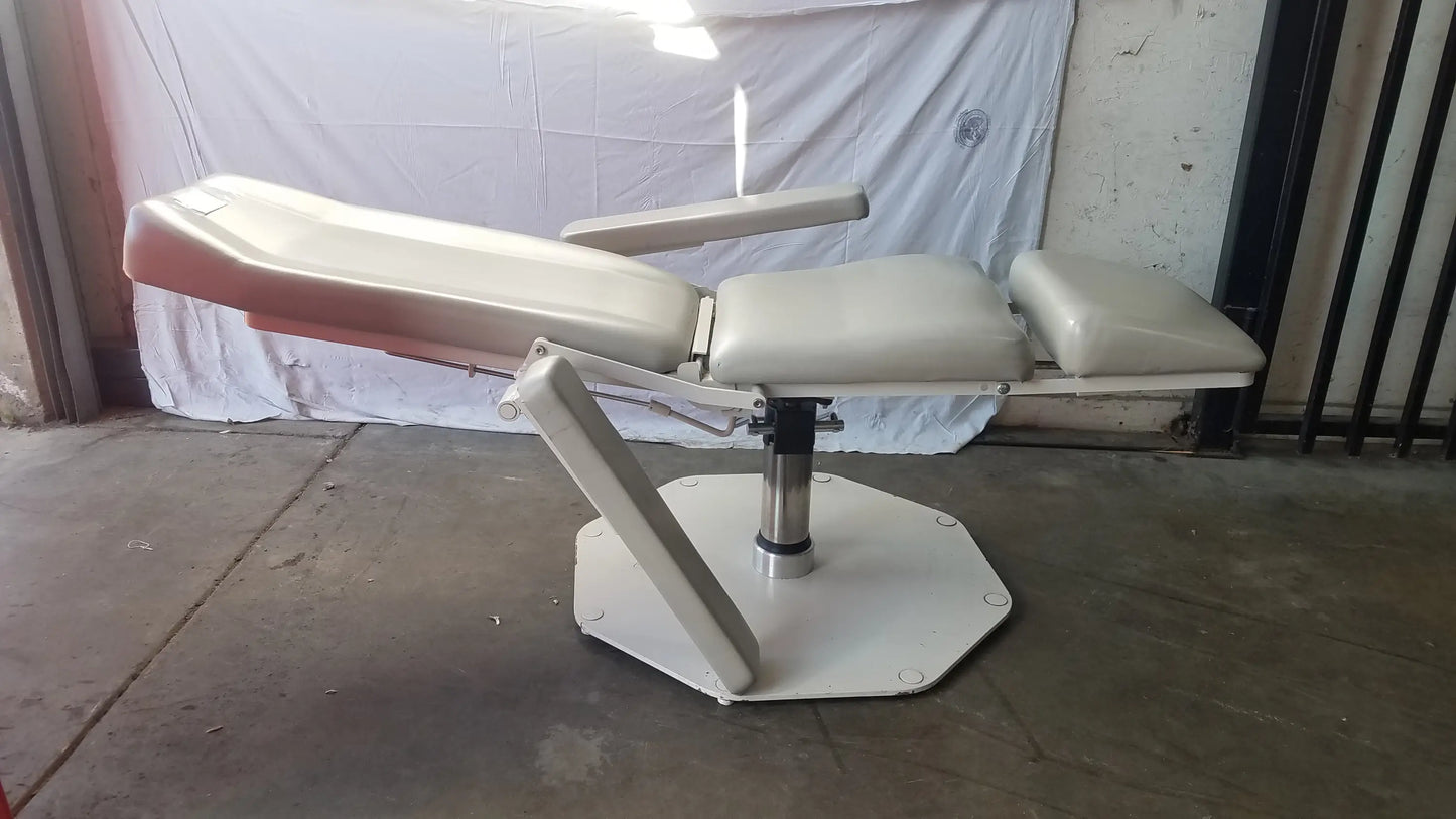 Beige upholstered umf medical 8675 adjustable phlebotomy chair with armrests and hexagonal base for examination use