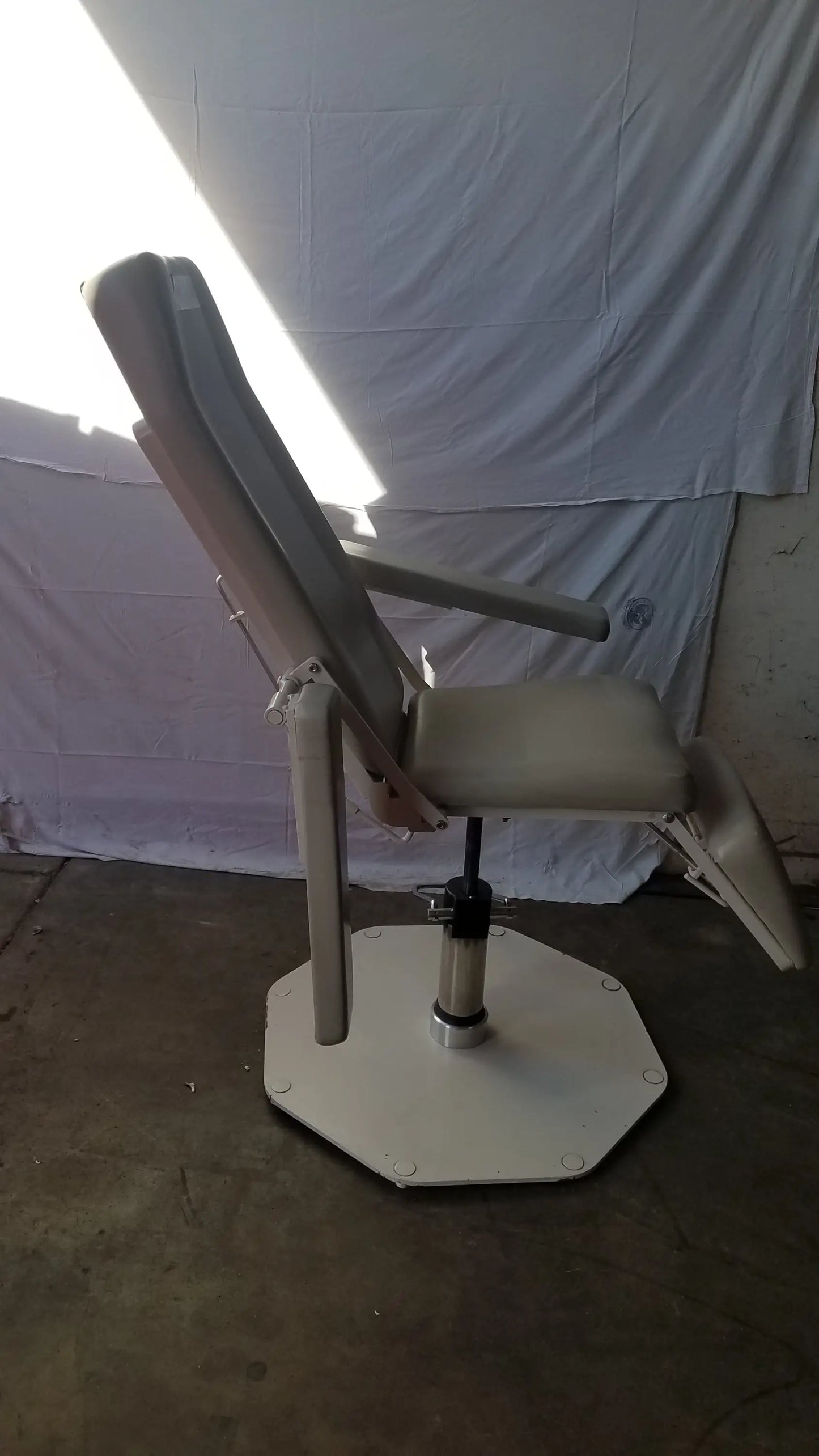 Beige upholstered UMF Medical 8675 adjustable phlebotomy chair with adjustable recline and octagonal base