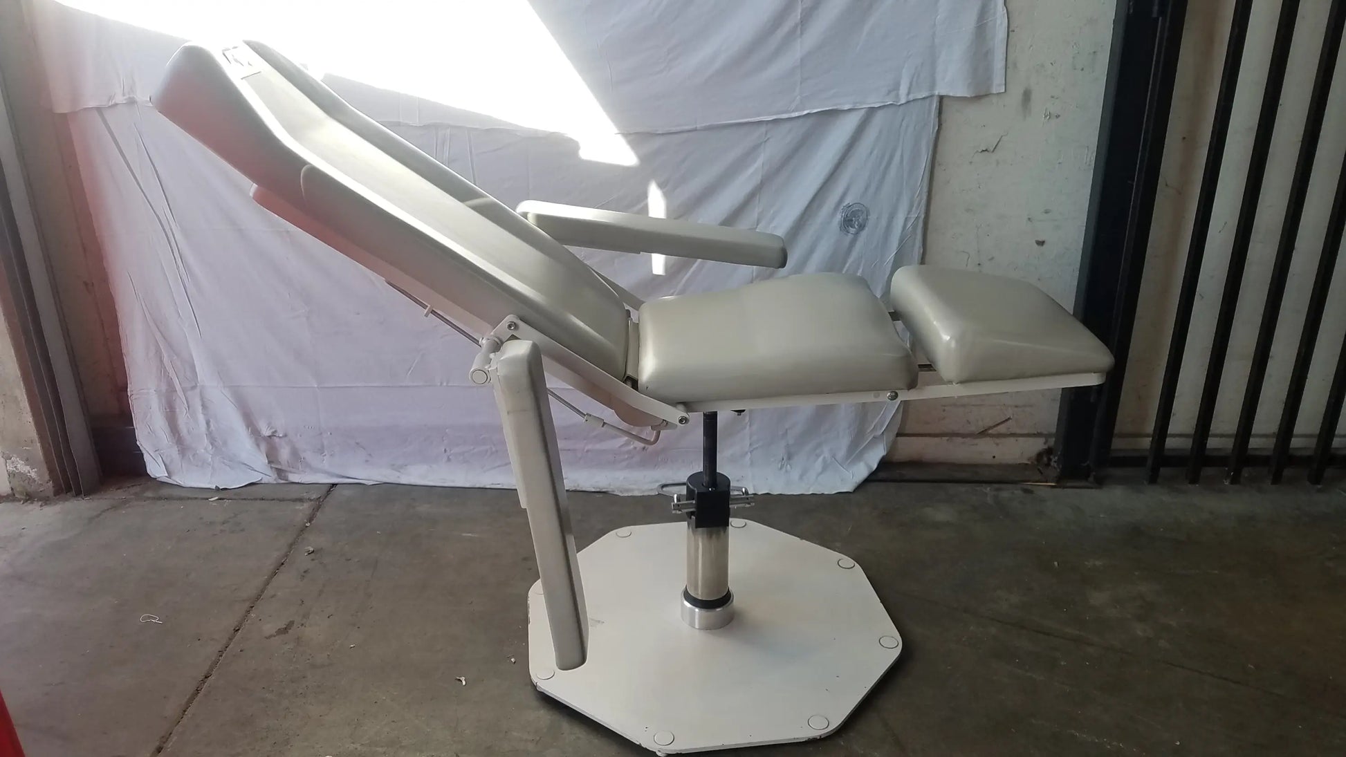 Beige upholstered UMF Medical 8675 adjustable phlebotomy chair with adjustable armrests and hexagonal base