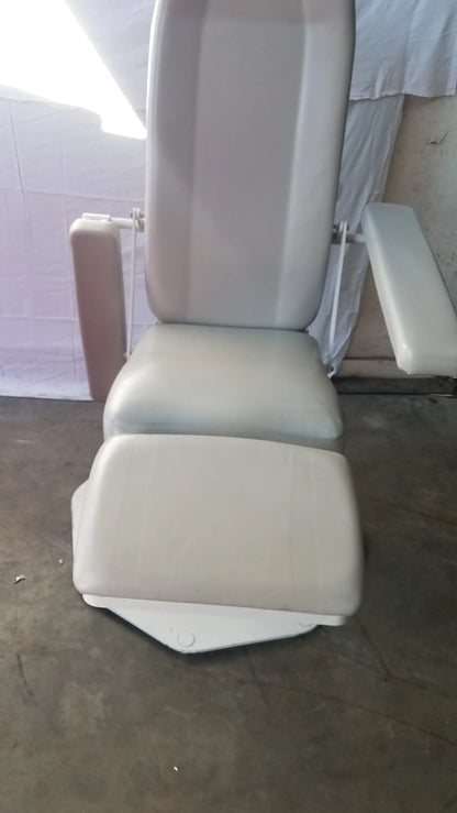 Beige upholstered UMF Medical 8675 adjustable phlebotomy chair with armrests and matching footrest for medical use
