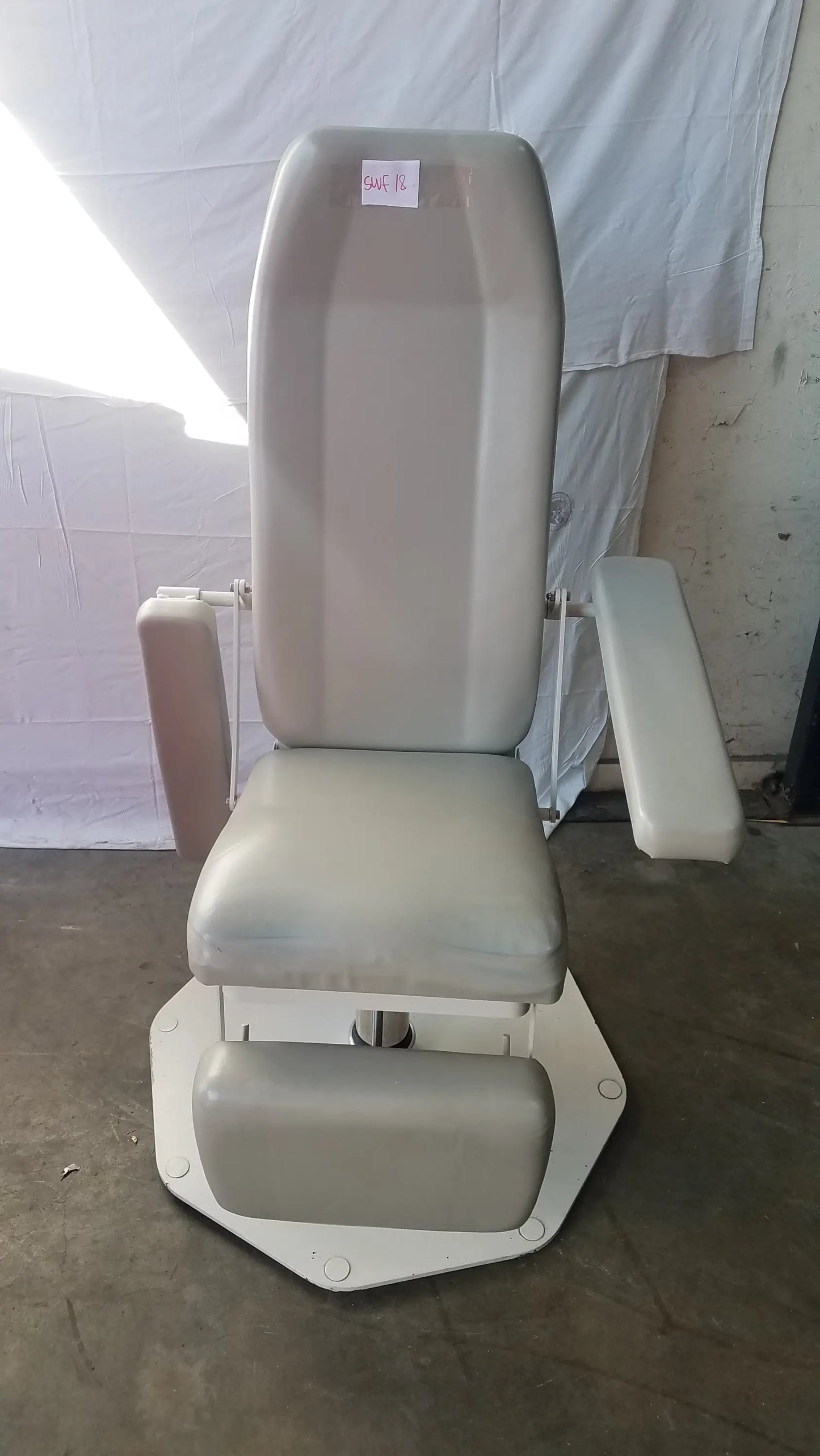 Gray upholstered UMF Medical 8675 phlebotomy chair with adjustable armrests and footrest for medical examinations
