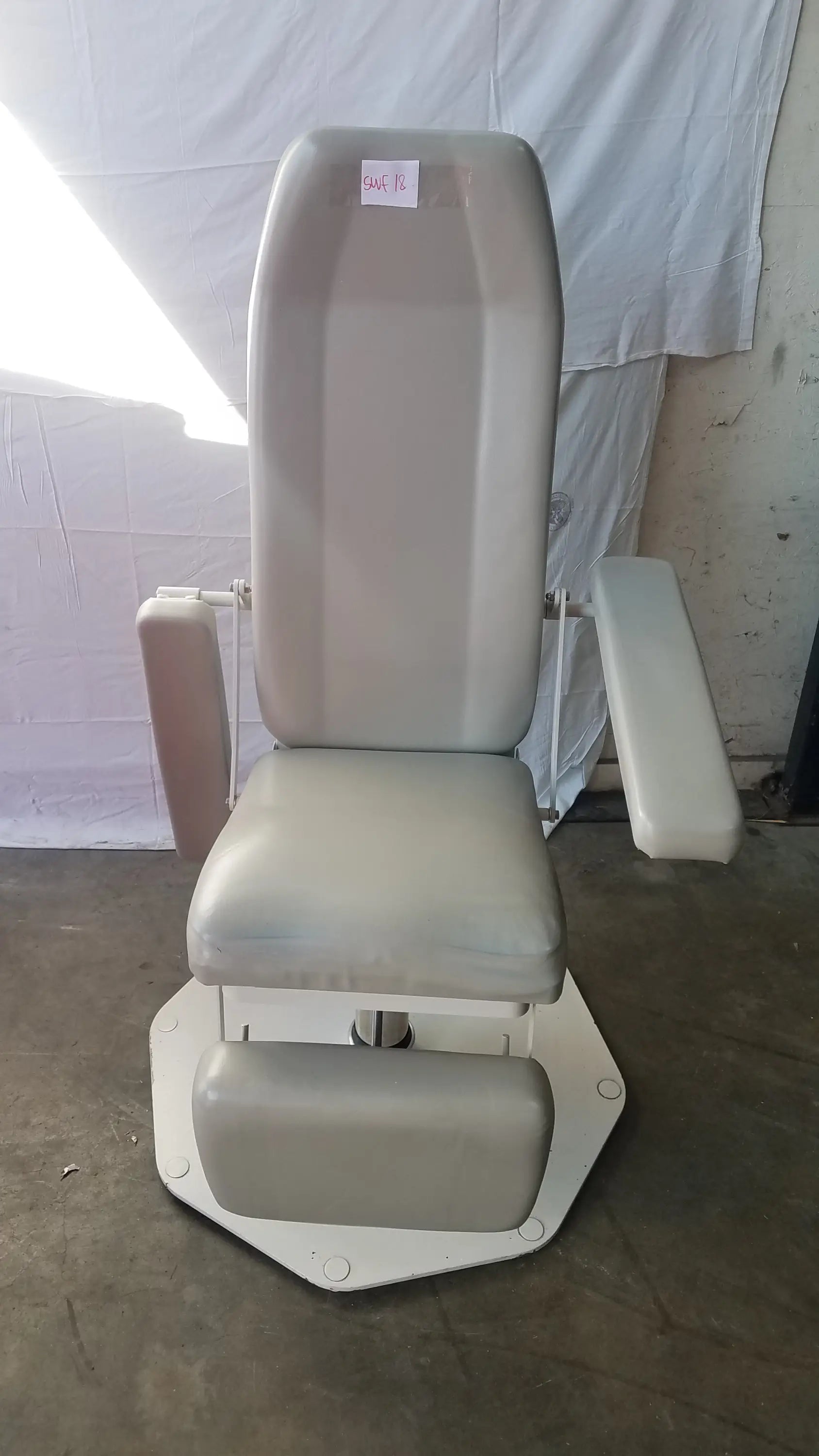 Gray upholstered UMF Medical 8675 phlebotomy chair with adjustable armrests and footrest for medical examinations