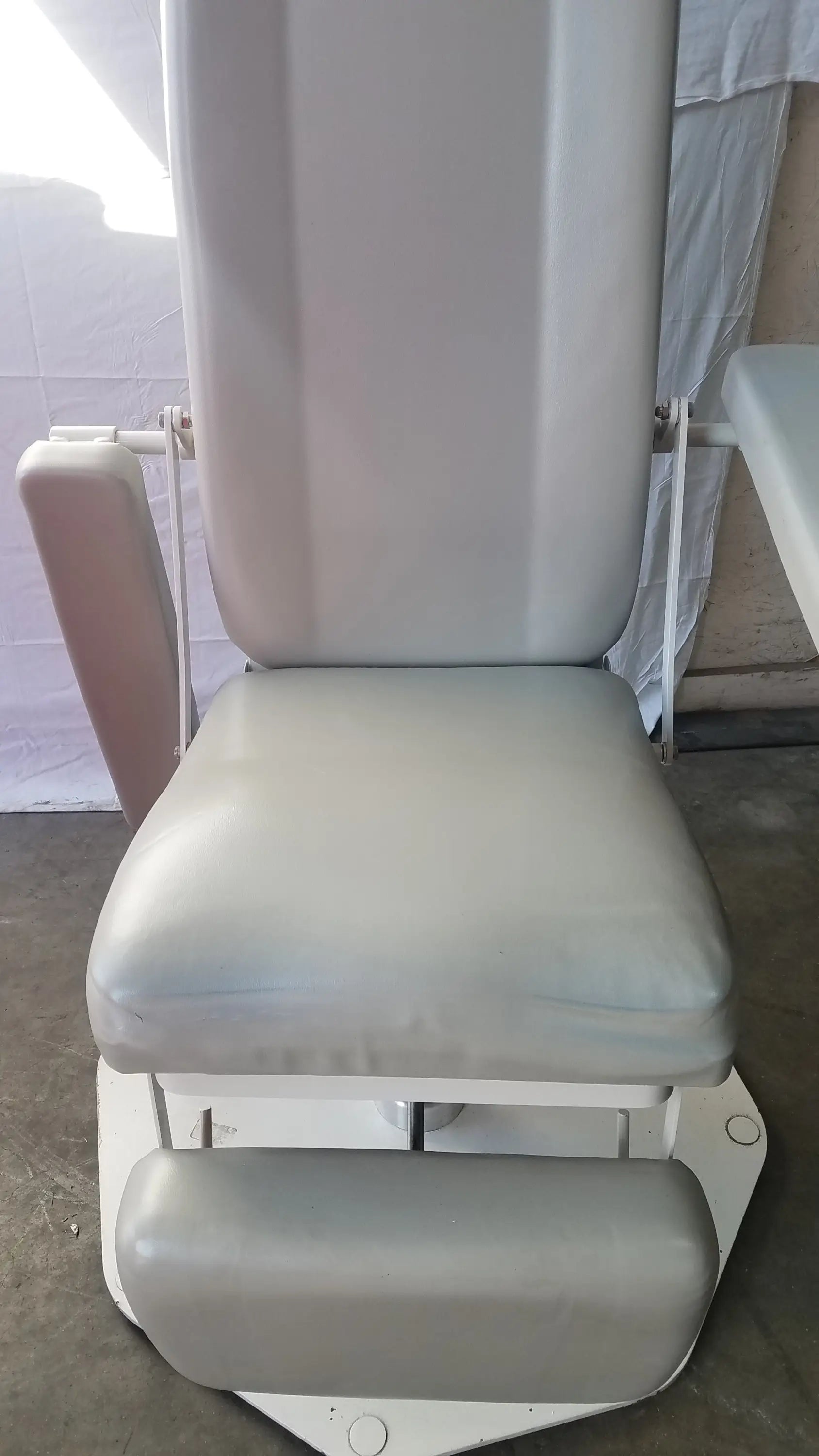 Gray upholstered umf medical 8675 adjustable phlebotomy chair with padded seat backrest and footrest on white metal frame