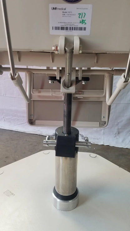 Silver cylindrical medical device base with black central component and metallic accents for umf medical adjustable phlebotomy chair