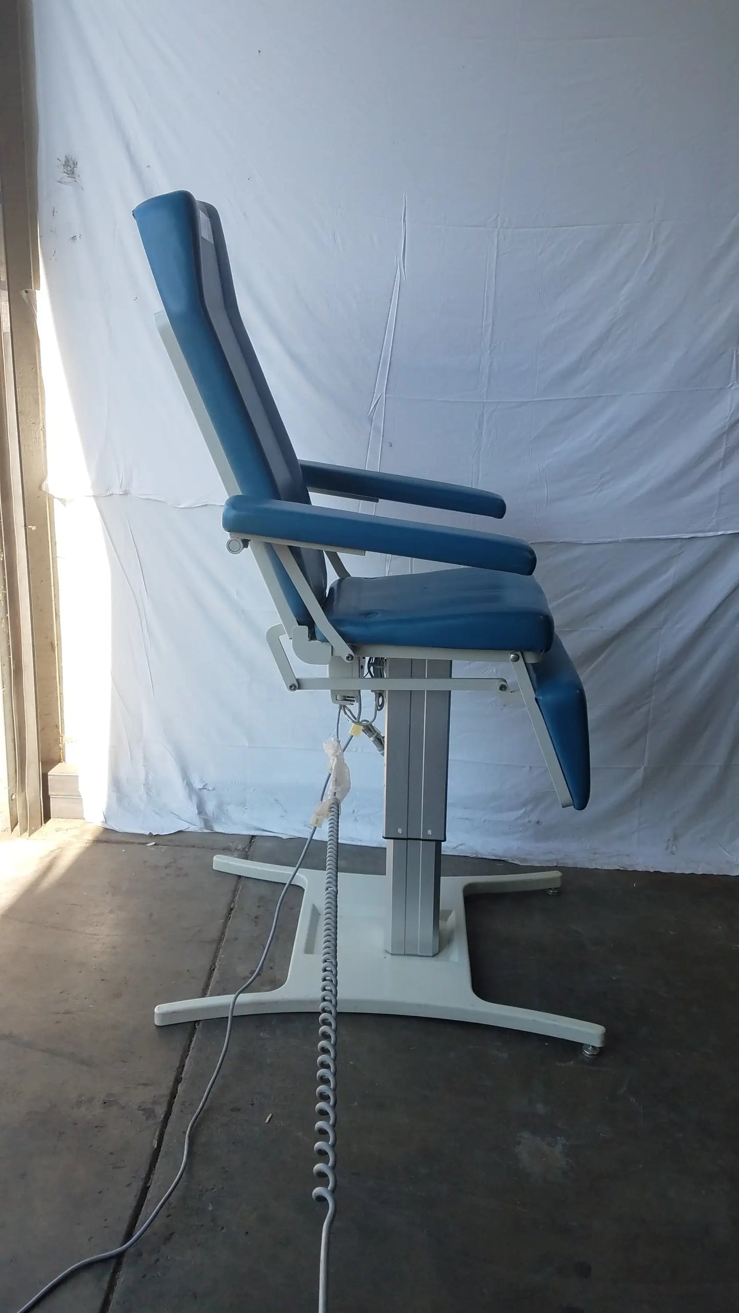 Blue upholstered UMF 29ZE 8677 power exam phlebotomy chair with silver metal frame and adjustable height mechanism