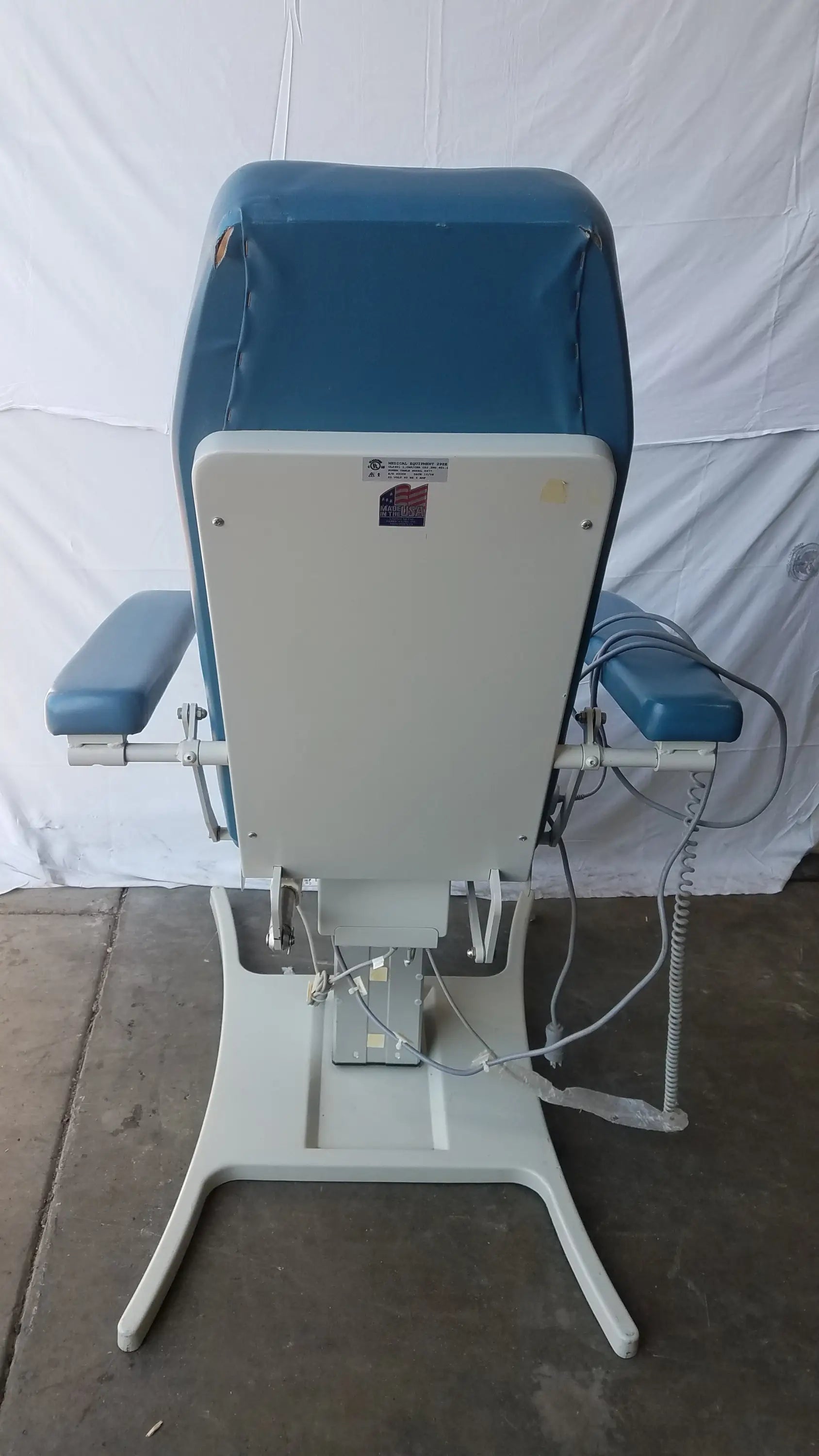 Blue upholstered UMF Medical Equipment 29ZE 8677 power exam phlebotomy chair with white metal frame and adjustable armrests