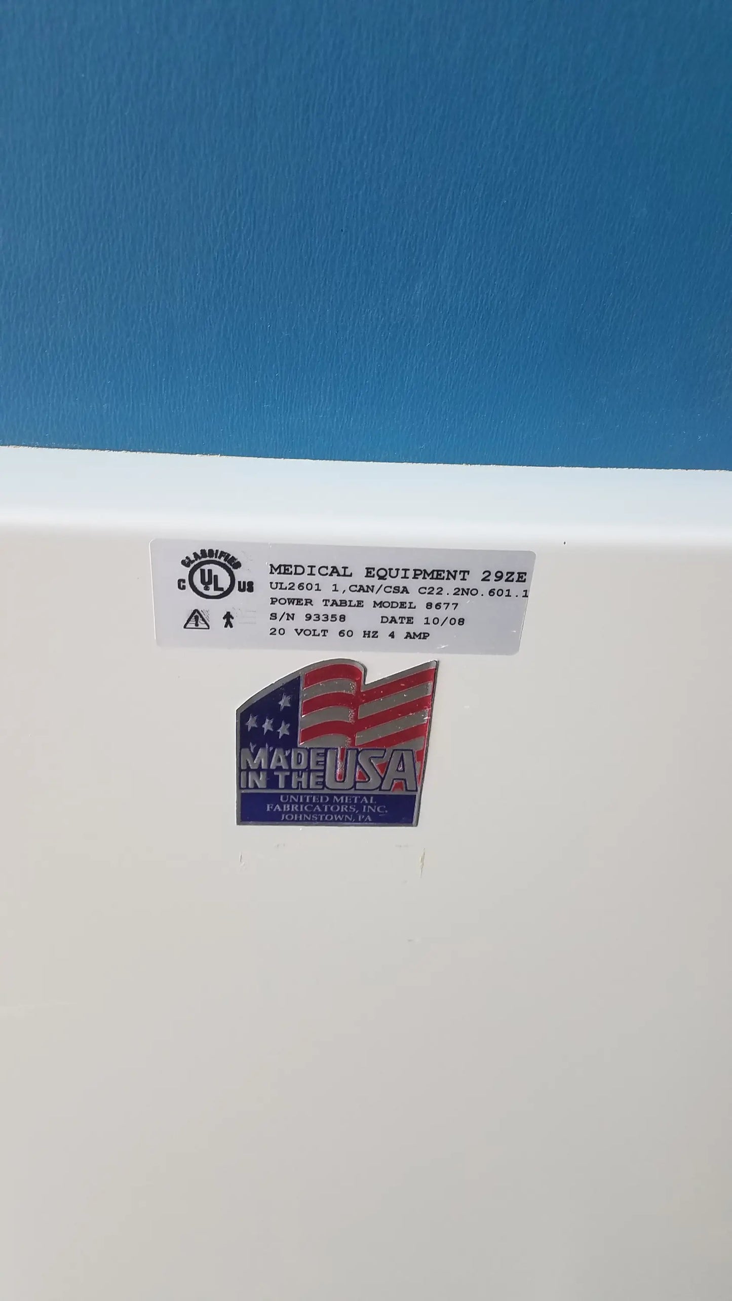 White umf medical equipment 29ze 8677 power exam phlebotomy chair back with blue made in the usa emblem and labels