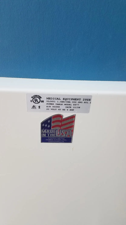 White umf medical equipment 29ze 8677 power exam phlebotomy chair back with blue made in the usa emblem and labels