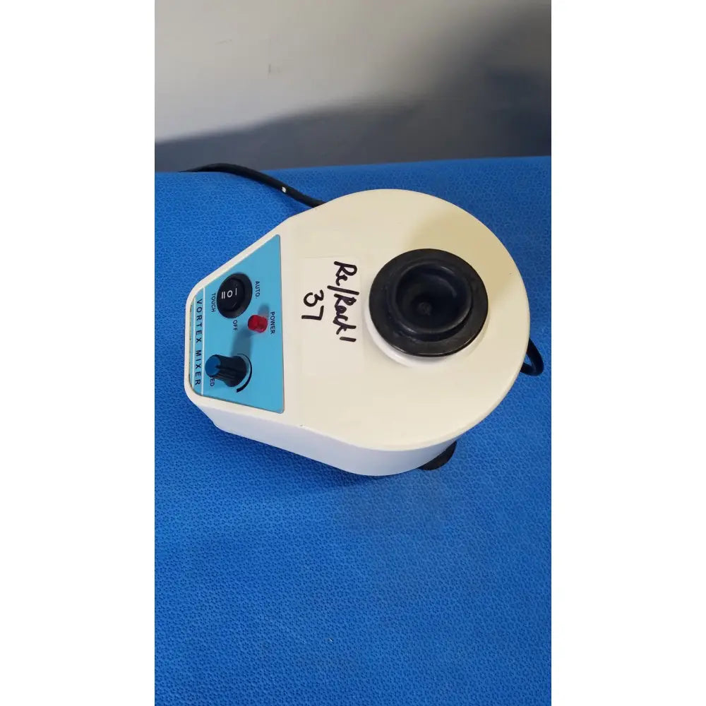 White plastic unico vortex mixer l-vm 100 with blue control panel and black rotor chamber showing back side label