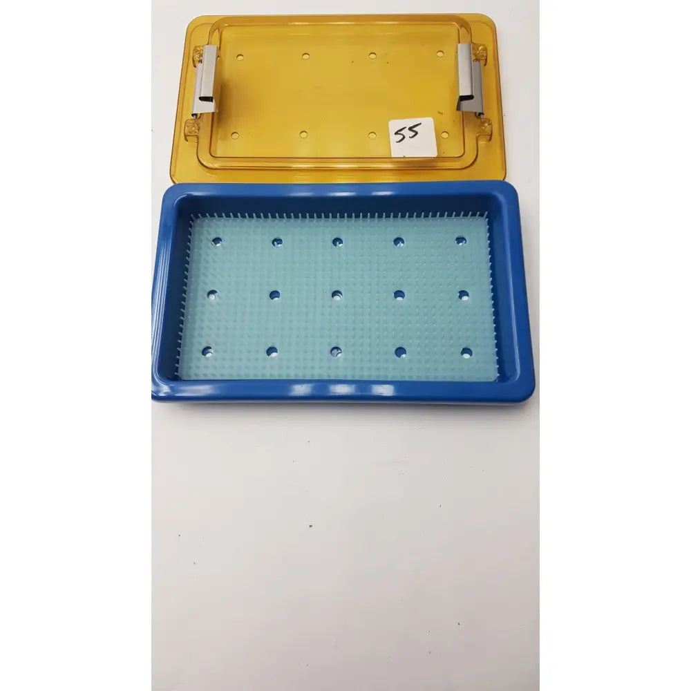 Blue and yellow plastic universal instrument sterilization container with finger matt and circular indentations tray