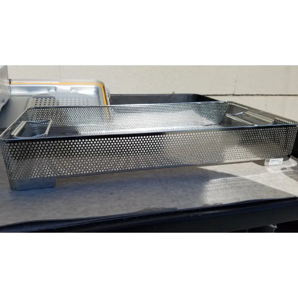 Stainless steel perforated surgical instrument tray with integrated handles in v.mueller dincd3-5lt genesis carefusion sterilization container