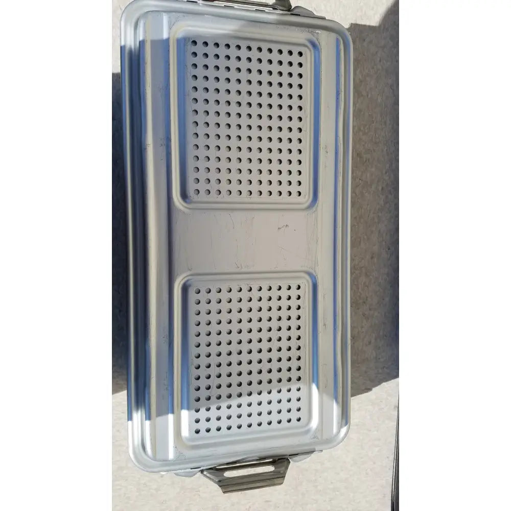 Silver stainless steel food tray with two rectangular perforated sections and reinforced edges for dincd3-5lt genesis carefusion sterilization container
