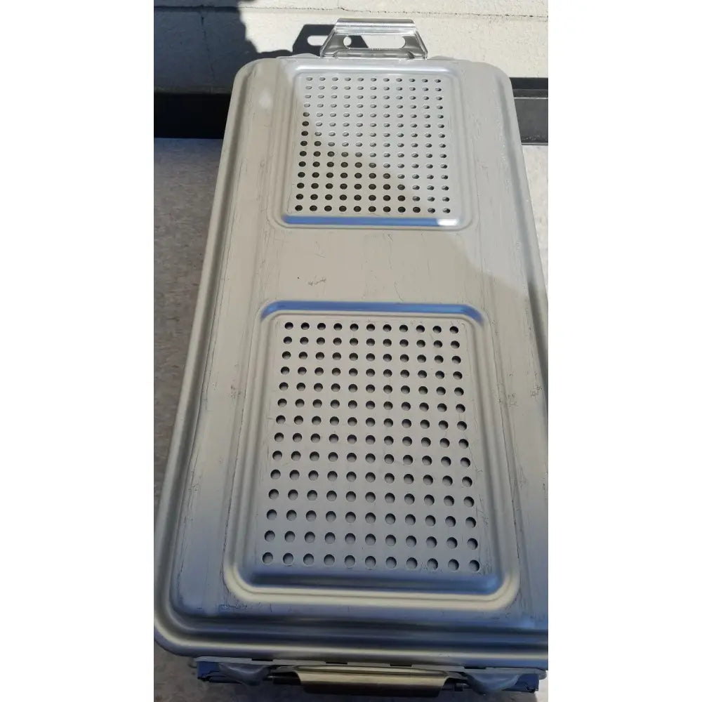 Silver metallic rectangular dincd3-5lt genesis carefusion sterilization container with two perforated sections and handle