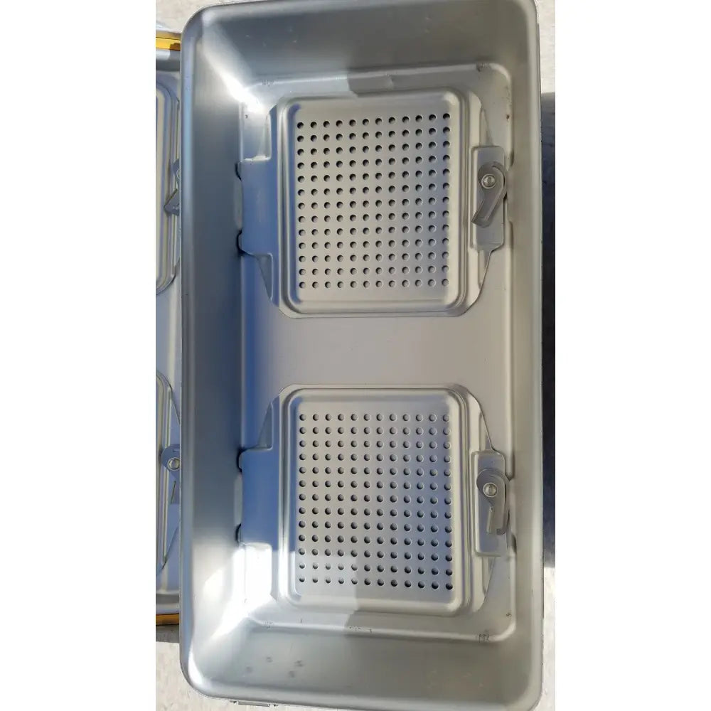 Silver metallic genesis sterilization container dincd3-5lt with two perforated sections and blue plastic latches