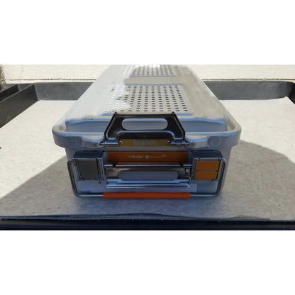 Gray and orange plastic genesis sterilization container dincd3-5lt with black handle perforated lid and metal latches