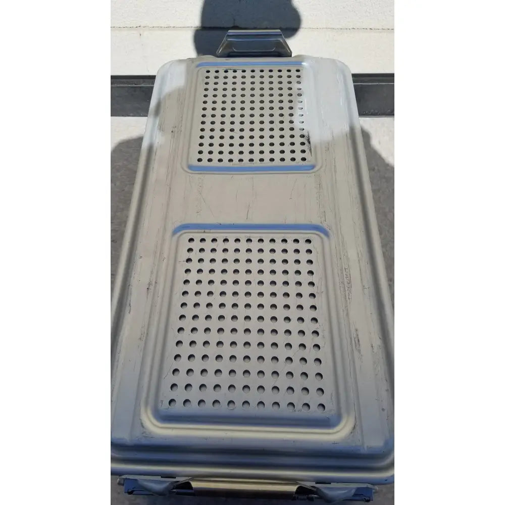 Gray plastic pet carrier with blue trim and perforated sections used as genesis sterilization container dincd3-5lt model