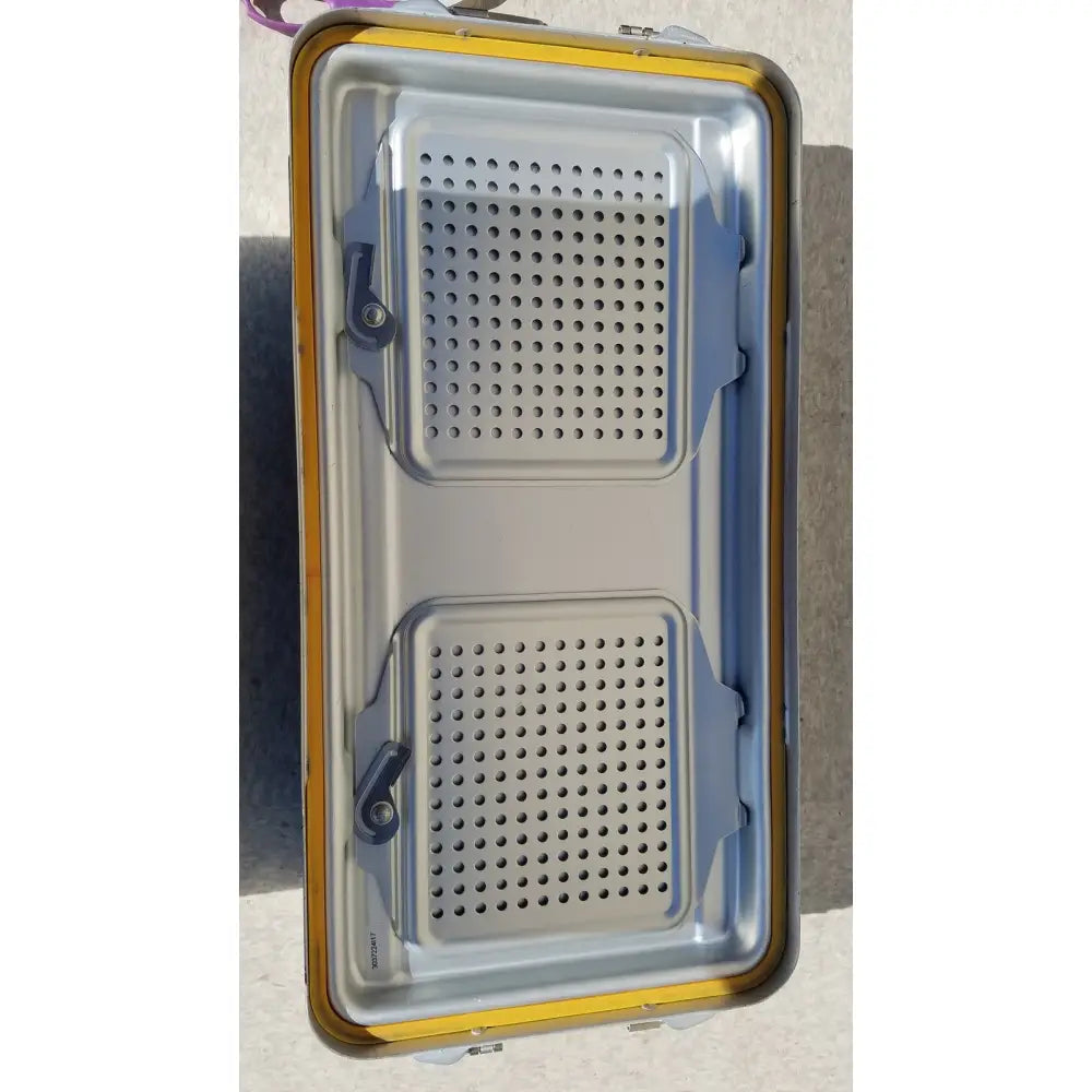 Yellow and gray metal v.mueller dincd3-5lt genesis sterilization container with two perforated compartments 5 inches deep